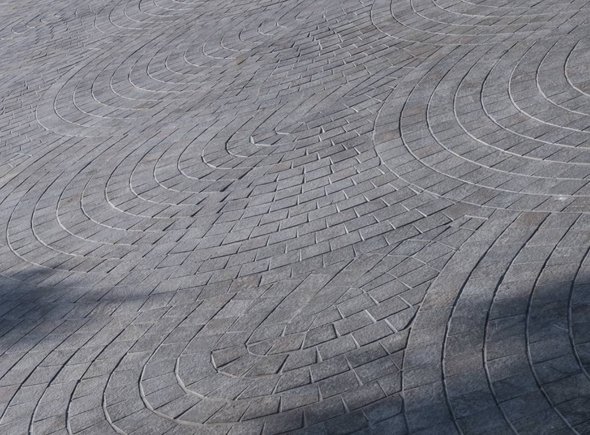 Natural stone pavers in grey and ochre with flamed - brushed finish