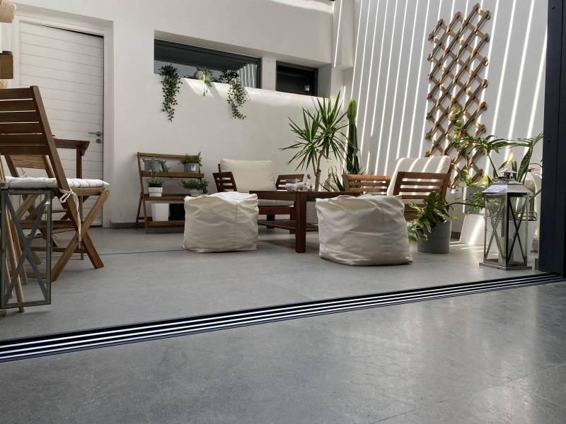 Large-format slabs flooring with Kahla Brushed Grey Moroccan highly resistant limestone for a terrace in a villa