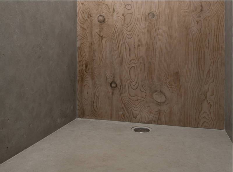 Walls in giant formats cut in Avalon gray natural stone and Italian shower tray machined in the mass in brushed natural stone