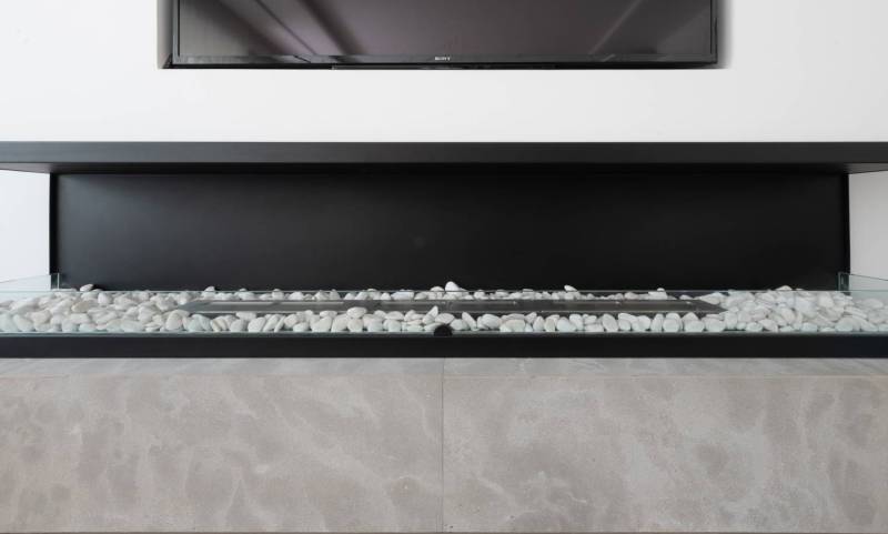 Modern and cosy fireplace in stone coating in apartment renovation project in London, United Kingdom, low price