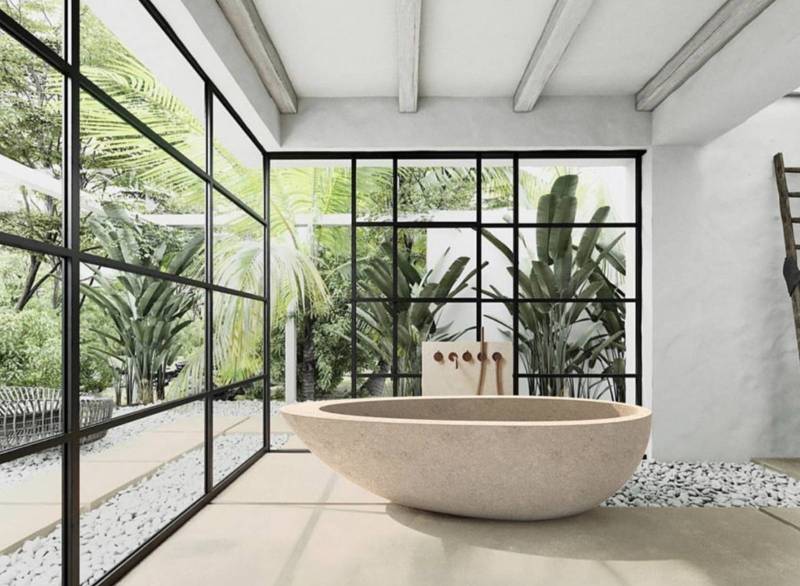 The Zola Beige natural stone bathtub, with a graceful almond design, for an exceptional bathroom.