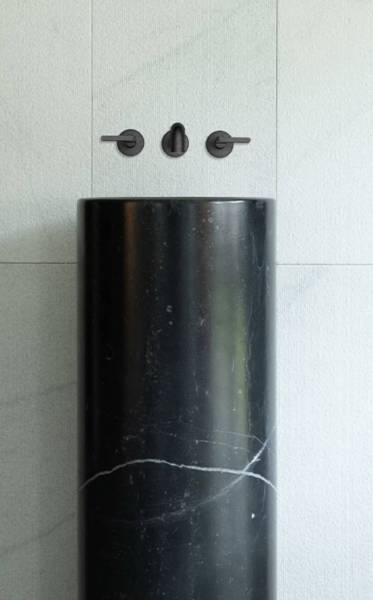 Exceptional sink in dark stone with white subtle veining, low priced, for a bathroom interior in Oakland, California